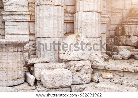 Classical old greek columns and wall background with stone floor and sculpture of a horse head