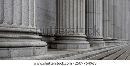 Classical pillars row in an office building facade. Stone colonnade and stairs detail. 