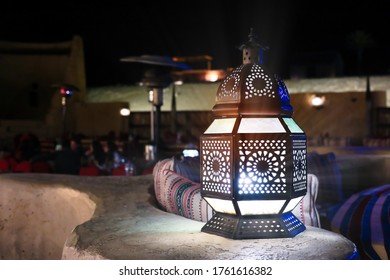 Classical And Retro  Arabia Styled Middle Eastern Lantern Lit At Night With Crafted Artwork Or Decorative Stained Glass With Metal Work Lantern Used In Festive Arabesque Seasons