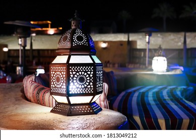 Classical And Retro  Arabia Styled Middle Eastern Lantern Lit At Night With Crafted Artwork Or Decorative Stained Glass With Metal Work Lantern Used In Festive Arabesque Seasons