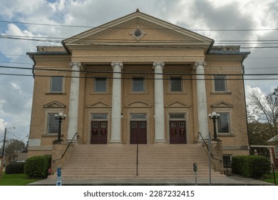 The Classical Revival style historic First United Methodist Church with a five-bay front facade and a pedimented portico with four Ionic columns on Lee Avenue in Lafayette, Louisiana, USA