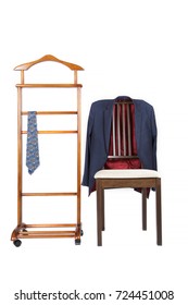 Classical tie on a jacket hanger stand and jacket is hanging on the chair. Isolated over white