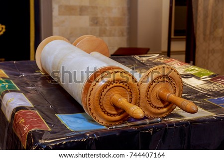 Classical Torah scrolls in a blue case with Hebrew letters. Torah is used in different religious services in a synagogue, especially during the holidays of the Jewish tishrei month.