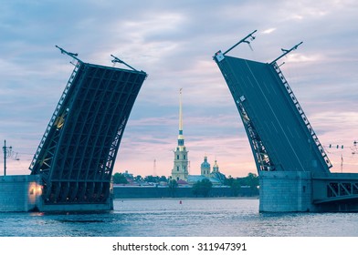 The classical view of the open Palace Bridge and Peter and Paul Fortress at dawn. Saint Petersburg. Russia