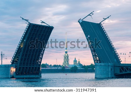 The classical view of the open Palace Bridge and Peter and Paul Fortress at dawn. Saint Petersburg. Russia