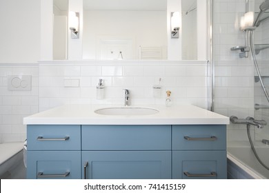 Classical White Bathroom Interior With Blue Cabinet