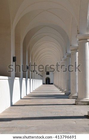 Classical white colonnade  with sharp shadows in perspective.