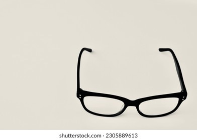 The classics eyeglass with black frames against gray background.
