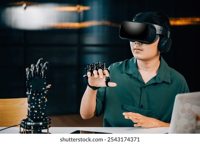 In a classroom Asian teenager wearing VR glasses and controlling a robot arm project. Immersed in robotics programming blending technology learning and STEM education. moves a robotic hand