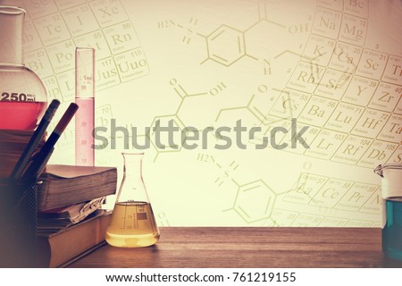 Classroom desk of chemistry teaching with books and instruments. Chemical sciences education concept. Horizontal composition. Front view