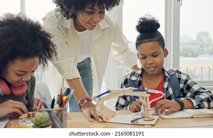Classroom with diverse learners of happily African American students and teacher doing activities together. The teacher is teaching, guiding and talking to the children in diverse. - Powered by Shutterstock