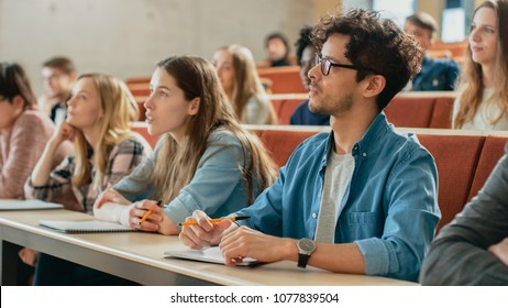 In the Classroom Multi Ethnic Students Listening to a Lecturer and Writing in Notebooks. Smart Young People Study at the College. - Shutterstock ID 1077839504
