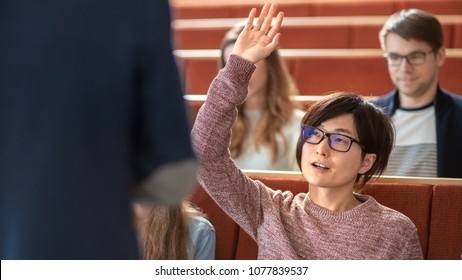 In the Classroom Smart Asian Student Raises Hand and Asks Lecturer a Question. Multi Ethnic Group of Modern Bright Students at the College.