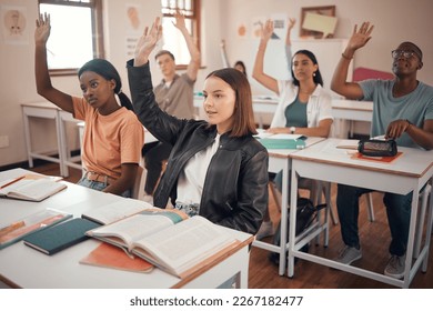 Classroom, students and hands for question, knowledge or education with diversity group, youth and learning development. Hand sign, scholarship information and teenager in school desk for course exam - Shutterstock ID 2267182477