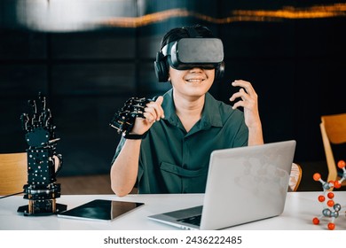 In a classroom teenager wears VR glasses while experimenting with a robot arm project. Integrating robotics programming into STEM education exploring futuristic technology. moves a robotic hand