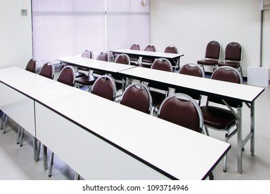 Classroom with white table with crimson chair