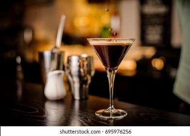 classy bartender garnish martini espresso cocktail drink foam coffee bean on top bar counter