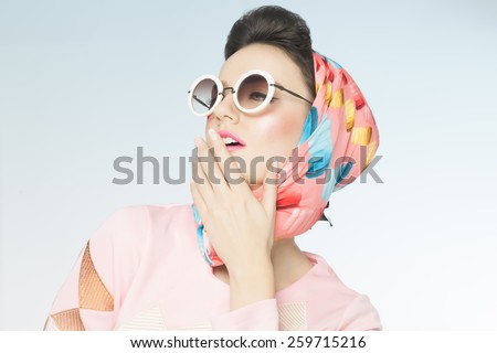 Classy chic sixties style fashion retro woman. Sunglasses and silk scarf.