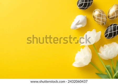Classy Easter concept, displaying rich black and gold eggs from top view, tasteful bunny statue, and tulips bouquet, all laid out on bright yellow ground, with space for words or promotion