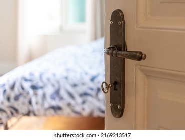 Classy Hotel Room Or House Bedroom Interior. Door Open, Retro Door Knob And Key On White Vintage Wooden Door, Close Up View.