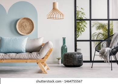 Classy Living Room Interior With Scandinavian Futon Sofa, Pouf, Armchair And Urban Jungle