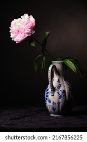 Classy Studio Lit Pink White Peony In A Classic Delft Pottery Jug On Black.