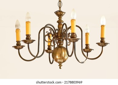Classy vintage hanging lights for a grand foyer or dinning room. Golden candle like lighting object for a royal Victorian interior style design. Brass chandelier hanging with many light bulbs. - Shutterstock ID 2178803969