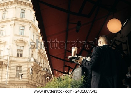 A classy waiter with a coffee in Vienna