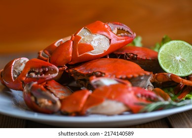 claw crab cooking food seafood plate with herbs spices lemon lime salad, fresh crab on white plate seafood sauce, boiled or steamed crab red in the restaurant