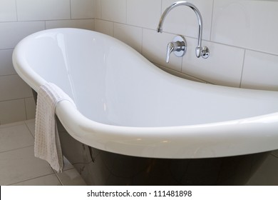 Claw Foot Bath In A White Tiled Bathroom