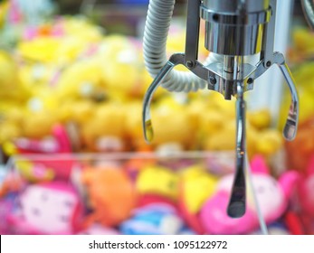 Claw Machine In The Amusement Park Of The Mall Which Insert Coin And Press The Control Button To Steel Claw For Pull Up The Doll, Skill Crane Or Teddy Picker Is Game For Play To Fun.