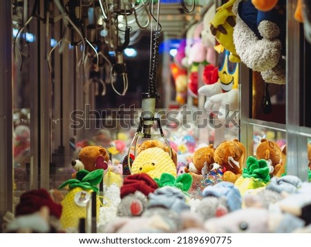 Claw Machines Toy Arcade game with stuffed animal toys on carnival. Entertainment for children in the amusement park