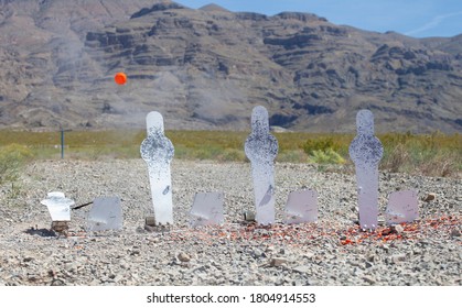 Clay Bird Released From A Steel Silhouette After Being Struck By A Shotgun Blast