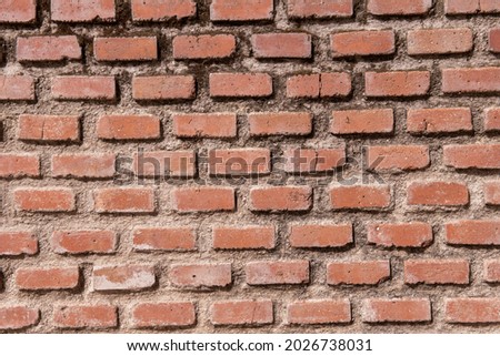 clay brick wall with cracks and moss between the cement joints. Vector clay texture background