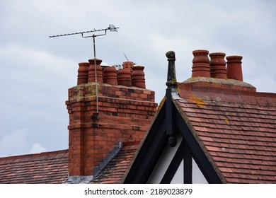 Clay Chimney Pots On The Top Of Red Brick Chimney Stack Of A Residential House