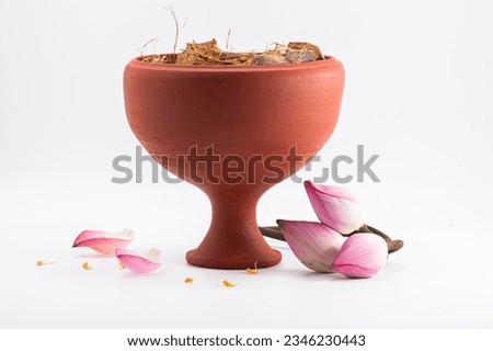 CLAY DHUNUCHI WITH LOTUS ISOLATED ON WHITE BACKGROUND.