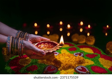 Clay diya lamps lit during diwali celebration, Diwali, or Deepavali, is India's biggest and most important holiday.