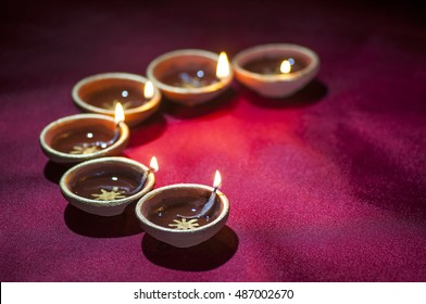 Clay diya lamps lit during Diwali Celebration. Greetings Card Design Indian Hindu Light Festival called Diwali