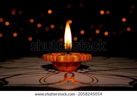 Clay Diya (Lantern) lamps lit during Diwali celebration. Greetings Card Design Indian Hindu Light Festival called Diwali.