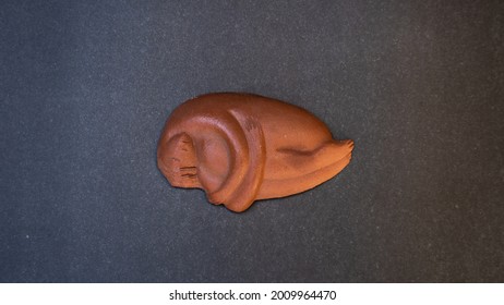 Clay Figurine In The Fetal Position