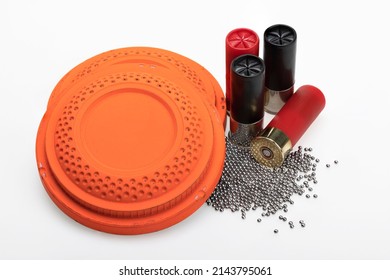 Clay Flying Target And Shotgun Shell Ammunition With Lead Pellets On White Background , Gun And Shooting Game