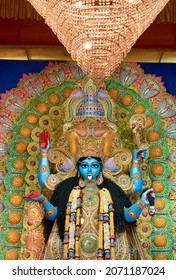 Clay made idol of Hindu Goddess Kali with dazzling decoration inside a puja pandal (temporary place for idol worship) during Kali puja festival in Kolkata. The goddess is holding slain demon head.