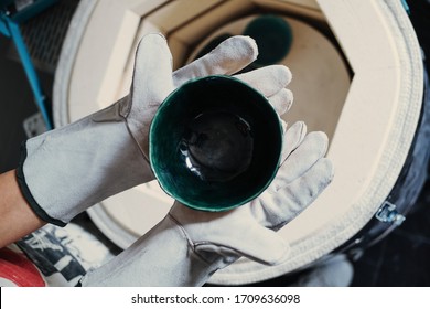 Clay Master Hands Wearing Gloves Holding Cup From Ceramic Kiln