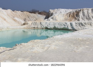 Clay Mining. Beautiful Background Of White Clay. Blue Water.