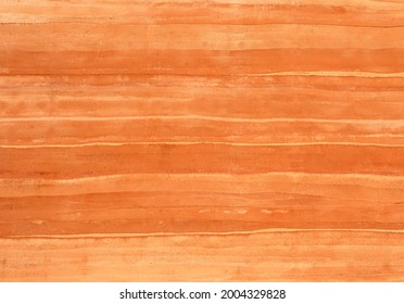 Clay orange ochre, Rammed Earth grunge texture background. Compacted sand gravel clay building with wall layers of soil color natural earth tones of warm autumn. Raw materials environmentally friendly