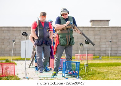 Clay Pigeon Shooting. An Athlete Shoots A Gun At Moving Targets, Sport Gun Shooting, Clay Pigeon Shooting. Training Process At The Shooting Range. Cyprus, Larnaca - August 20, 2022