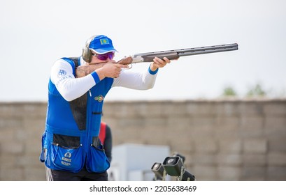 Clay Pigeon Shooting. An Athlete Shoots A Gun At Moving Targets, Sport Gun Shooting, Clay Pigeon Shooting. Training Process At The Shooting Range. Cyprus, Larnaca - August 20, 2022