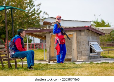 Clay Pigeon Shooting. An Athlete Shoots A Gun At Moving Targets, Sport Gun Shooting, Clay Pigeon Shooting. Training Process At The Shooting Range. Cyprus, Larnaca - August 20, 2022