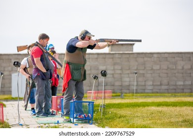 Clay Pigeon Shooting. An Athlete Shoots A Gun At Moving Targets, Sport Gun Shooting, Clay Pigeon Shooting. Training Process At The Shooting Range. Cyprus, Larnaca - August 20, 2022