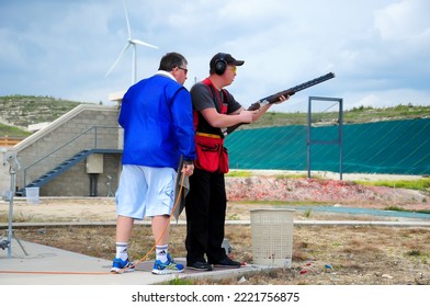 Clay Pigeon Shooting. An Athlete Shoots A Gun At Moving Targets, Sport Gun Shooting, Clay Pigeon Shooting. Training Process At The Shooting Range. Cyprus, Larnaca - August 20, 2022